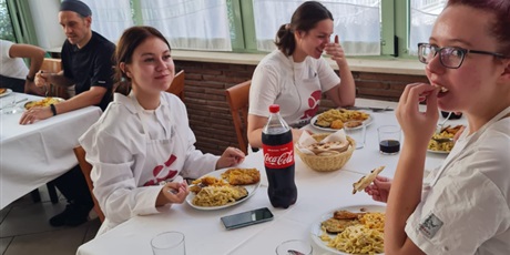 Powiększ grafikę: wizyta monitorująca w restauracji La Cappa - Wiktoria, Olivia i Natalia podczas obiadu pracowniczego, w tyle pracownicy La Cappa